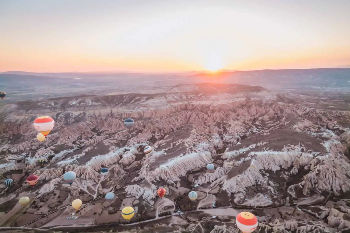 Hot-air balloons over the rocks of Cappadocia at sunrise