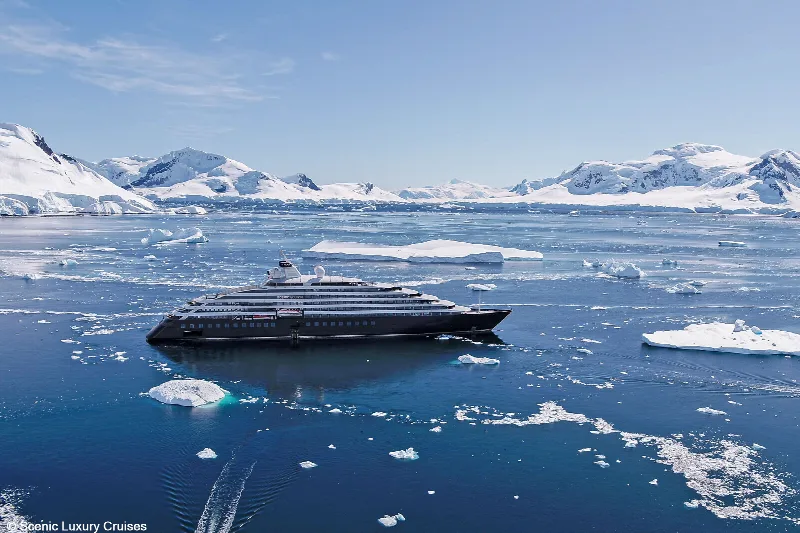 Scenic Eclipse among ice floes below Antarctic mountains